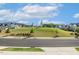 Spacious green space featuring a grassy hill and a sidewalk running around the perimeter of the neighborhood at 208 Dry Canyon Dr, Wendell, NC 27591