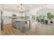 Open kitchen and dining area with white cabinets, an island, and stainless steel appliances at 208 Dry Canyon Dr, Wendell, NC 27591