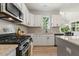 Close up of kitchen featuring white cabinetry, stainless steel appliances, and granite countertops at 208 Dry Canyon Dr, Wendell, NC 27591
