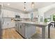 Kitchen featuring white cabinets, an island with a gray base, and stainless steel appliances at 208 Dry Canyon Dr, Wendell, NC 27591