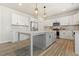 Kitchen area with white cabinets, a gray island, and stainless steel appliances at 208 Dry Canyon Dr, Wendell, NC 27591