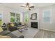 Comfortable living room featuring natural light, a ceiling fan, and a modern fireplace with a beautiful mantle at 208 Dry Canyon Dr, Wendell, NC 27591