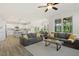Open-concept living room and kitchen area is furnished with cozy couches and a modern island at 208 Dry Canyon Dr, Wendell, NC 27591