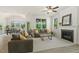 Bright living room and dining room area with large windows and a fireplace is perfect for entertaining at 208 Dry Canyon Dr, Wendell, NC 27591