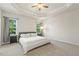 Main bedroom with tray ceiling, carpet, and natural light at 208 Dry Canyon Dr, Wendell, NC 27591