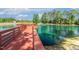 Enjoy this scenic view from the dock with a tranquil community pond with fountain, surrounded by lush landscaping at 208 Dry Canyon Dr, Wendell, NC 27591