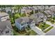 Aerial view of the light blue home showcasing the manicured landscaping, neighborhood, and roof at 2135 Vittorio Ln, Apex, NC 27502