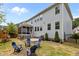 Spacious backyard with blue chairs, hot tub, and outdoor grill, perfect for relaxing and entertaining at 2135 Vittorio Ln, Apex, NC 27502