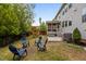 Fenced backyard view showcases a play area, seating, a hot tub, and an outdoor grill at 2135 Vittorio Ln, Apex, NC 27502