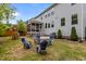 Wide backyard view showcasing a hot tub, grill, screened-in porch, and play area at 2135 Vittorio Ln, Apex, NC 27502