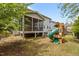 Backyard featuring a ' play area, a screened porch, and a hot tub at 2135 Vittorio Ln, Apex, NC 27502