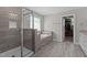 Spa-like bathroom featuring a glass enclosed shower, separate tub, and walk-in closet at 2135 Vittorio Ln, Apex, NC 27502