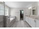 Spa-like bathroom with shower, tub, and vanity provides a serene space for relaxation at 2135 Vittorio Ln, Apex, NC 27502