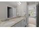 Bathroom with dual sinks, granite countertops, white cabinetry, and tile floors at 2135 Vittorio Ln, Apex, NC 27502