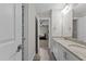 Bathroom with dual sinks, granite countertops, white cabinetry, and tile floors at 2135 Vittorio Ln, Apex, NC 27502