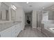 Bright, updated bathroom features a walk-in shower, bathtub, and double vanity with granite countertops at 2135 Vittorio Ln, Apex, NC 27502