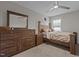 Bedroom features a wood bed frame with coordinating furniture, neutral paint, carpet and natural light at 2135 Vittorio Ln, Apex, NC 27502