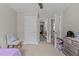 Bedroom features neutral paint, plush carpet, standard closet, ample natural light, and ceiling fan at 2135 Vittorio Ln, Apex, NC 27502