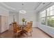 Dining room with hardwood floors, a modern chandelier, and glass table with wood base at 2135 Vittorio Ln, Apex, NC 27502
