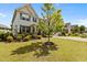 Charming two-story home featuring a well-maintained lawn and manicured landscaping at 2135 Vittorio Ln, Apex, NC 27502