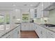 Bright kitchen with white cabinets, granite countertops, tile backsplash, and stainless steel appliances at 2135 Vittorio Ln, Apex, NC 27502