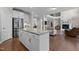 Open concept kitchen with a large island, stainless steel appliances, and views into the living room at 2135 Vittorio Ln, Apex, NC 27502