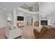 Spacious living room featuring a fireplace, hardwood floors, and staircase to the second floor at 2135 Vittorio Ln, Apex, NC 27502
