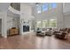 Bright, open living room with fireplace, lots of windows, and open floor plan to kitchen at 2135 Vittorio Ln, Apex, NC 27502