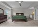 Well-lit main bedroom with a ceiling fan, dresser, and carpeted floor provides comfort at 2135 Vittorio Ln, Apex, NC 27502