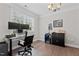 Office with hardwood floors, natural light, two monitors, and modern black desk at 2135 Vittorio Ln, Apex, NC 27502