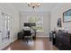 Office with a modern black desk, hardwood floors, natural light, and beverage cooler at 2135 Vittorio Ln, Apex, NC 27502