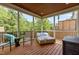Screened-in porch with tongue and groove ceiling, wood flooring, wicker furniture, and backyard view at 2135 Vittorio Ln, Apex, NC 27502