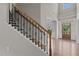 Elegant staircase with decorative iron railings and hardwood steps welcomes you into the home at 2135 Vittorio Ln, Apex, NC 27502