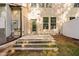 Backyard patio with steps leading up to the back door and several windows at 2242 Sweet Annie Way, Wake Forest, NC 27587