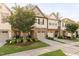 Charming townhomes with brick accents, attached garages, and manicured landscaping at 2242 Sweet Annie Way, Wake Forest, NC 27587
