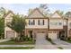 Exterior view of the townhomes features manicured lawns, attached garages, and attractive landscaping at 2242 Sweet Annie Way, Wake Forest, NC 27587
