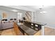 Open kitchen with wooden cabinets, granite countertops, stainless steel appliances, and breakfast bar seating at 2242 Sweet Annie Way, Wake Forest, NC 27587