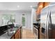 Modern kitchen featuring stainless steel appliances, wooden cabinets, and views to outdoor entry at 2242 Sweet Annie Way, Wake Forest, NC 27587
