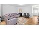 Inviting living room featuring gray walls, hardwood floors, a fireplace, and seating area with decorative rug at 2242 Sweet Annie Way, Wake Forest, NC 27587