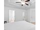 This bedroom features a tray ceiling with ceiling fan and white paint at 2242 Sweet Annie Way, Wake Forest, NC 27587