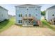 Blue house with a spacious backyard featuring a wooden deck and patio, blending outdoor living at 279 Hopewell Branch Ct, Smithfield, NC 27577