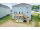 Blue house showcasing a wooden deck and patio with stairs leading to a spacious backyard at 279 Hopewell Branch Ct, Smithfield, NC 27577