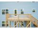 Blue house with a wooden deck and stairs, offering access to the backyard and a view of the surroundings at 279 Hopewell Branch Ct, Smithfield, NC 27577