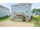 Backyard of a two-story home featuring a wooden deck with stairs and a concrete patio underneath at 279 Hopewell Branch Ct, Smithfield, NC 27577