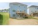 Two-story house with a wooden deck with stairs leading to the backyard and concrete patio at 279 Hopewell Branch Ct, Smithfield, NC 27577