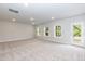 Spacious carpeted basement area with recessed lighting, large windows, and a walkout door to backyard at 279 Hopewell Branch Ct, Smithfield, NC 27577