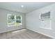 Bright bedroom with two windows offering natural light and neutral carpet flooring at 279 Hopewell Branch Ct, Smithfield, NC 27577