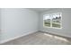 Bedroom with neutral walls and plush carpeting, featuring a window with neighborhood views at 279 Hopewell Branch Ct, Smithfield, NC 27577