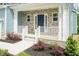 Charming front porch with stone accents, white railings, and a navy front door at 279 Hopewell Branch Ct, Smithfield, NC 27577
