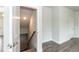 Open hallway with hardwood floors and stairs leading to the basement in new construction home at 279 Hopewell Branch Ct, Smithfield, NC 27577